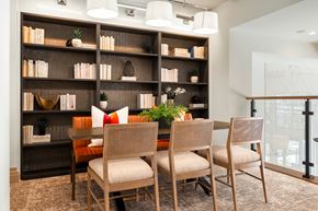 Hanover apartment for rent - a dining room with a table and chairs in front of a bookshelf