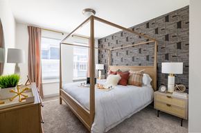 Elkridge apartment for rent - The Forge bedroom with a bed in front of a brick wall