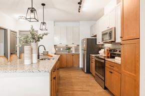Hanover apartment for rent - a kitchen with white cabinets and black appliances