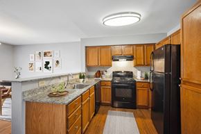 Landover apartment for rent - Kitchen with granite countertops and oak cabinets at Villages at Morgan Metro Apartments, Maryland