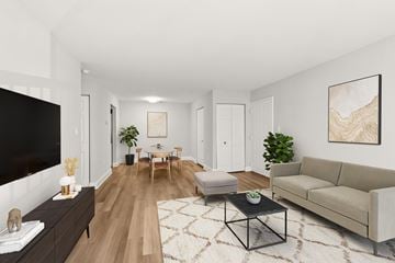 Columbia apartment for rent - A living room with a black TV, a wooden floor, and a large painting on the wall.