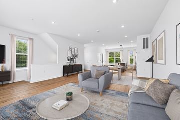 Hanover townhouse for rent - A living room with a grey couch and a rug.