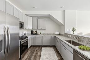 Elkridge townhouse for rent - a large kitchen with stainless steel appliances and granite counter tops