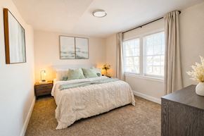 Capitol Heights apartment for rent - A bedroom with a large bed and a painting on the wall ighland Ridge Apartments, Capitol Heights, MD, 20743