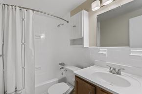 Wheaton apartment for rent - a white bathroom with a shower sink and toilet at Earle Manor Apartments, Wheaton, MD 20902