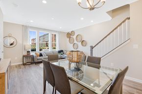 Elkridge townhouse for rent - a dining room with a glass table and chairs