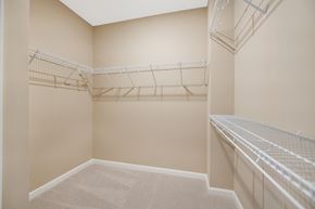 Elkridge townhouse for rent - a spacious walk in closet in a home with empty shelves