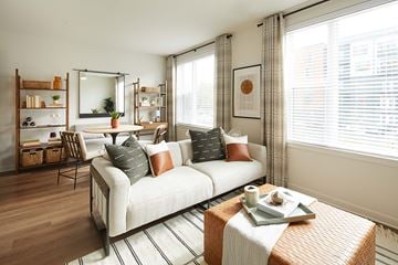 Greenbelt apartment for rent - A living room with a white sofa and a coffee table.