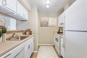Columbia apartment for rent - a kitchen with white appliances and white cabinets at Madison at Eden Brook, Columbia