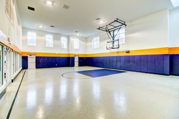 The large gym in the center of the building has a basketball hoop