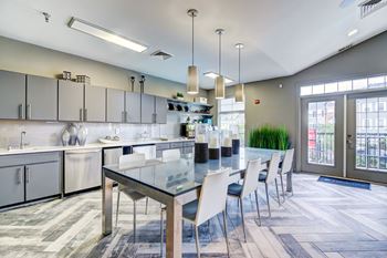 A large kitchen with a long table and chairs
