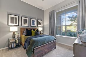 Farmers Branch apartment for rent - A bedroom with a bed, nightstand, and a window with curtains at Prairie Crossing, Texas