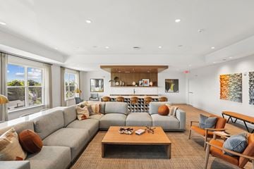 Frederick apartment for rent - A living room with a grey sofa and a wooden coffee table.