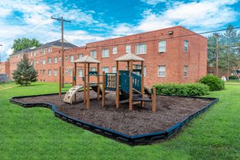 A playground in front of a brick building
