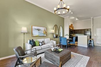 A living room with a white couch and a coffee table.