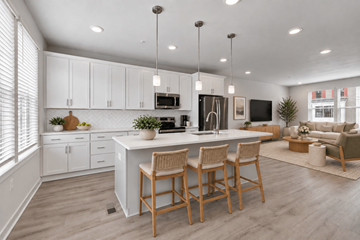 Brooklyn apartment for rent - A modern kitchen with white cabinets and a center island.