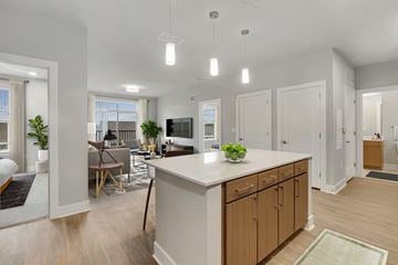 Bowie apartment for rent - a kitchen with an island and a living room with a couch