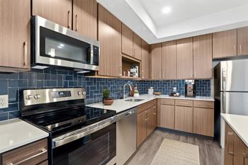 Fully equipped kitchen includes frost-free refrigerator, electric range, & dishwasher