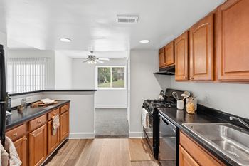 Galley kitchen with wood cabinets and gas range