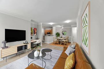 Camp Springs apartment for rent - A living room with a brown couch and a television.