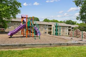 Columbia apartment for rent - Colorful playground with climbing wall and mulch surface at The Brook At Columbia Apartments, Columbia, MD