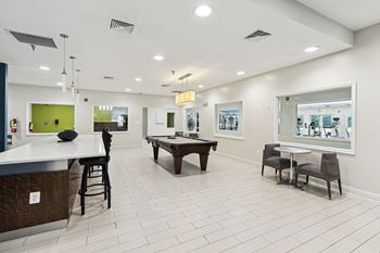 Resident clubhouse with billiards table and seating