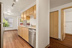 Bend apartment for rent - a kitchen with wood flooring and a stainless steel dishwasher