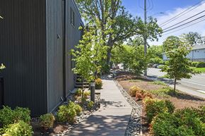Beaverton apartment for rent - A wooden building with a small garden in front.