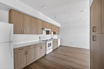 Campbell apartment for rent - A kitchen with wooden cabinets and a white countertop.