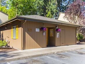 Woodburn apartment for rent - a small brown building with a door and a sign on it