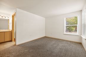 Bend apartment for rent - a bedroom with carpet and a window and a sink