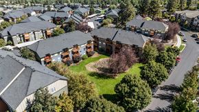 Bend apartment for rent - an aerial view of a neighborhood with houses and green grass