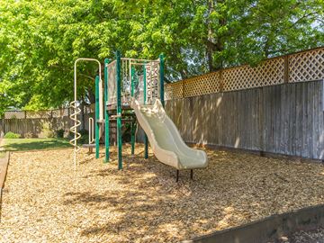 Gresham apartment for rent - a playground with a slide and climbing equipment in a backyard