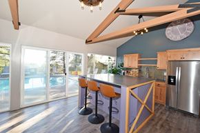 Lake Oswego apartment for rent - A kitchen with a purple wall and a bar area with stools.