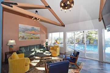 Lake Oswego apartment for rent - A living room with a yellow chair and a green couch.