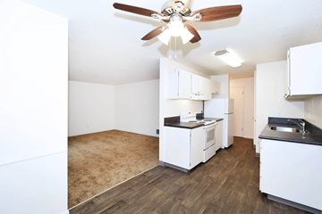 Beaverton apartment for rent - A kitchen with white cabinets and a wood floor.