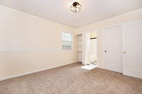 Portland apartment for rent - a bedroom with white walls and carpet and a door to a closet