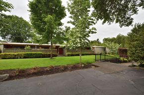 Milwaukie apartment for rent - the front of a house with a yard and trees