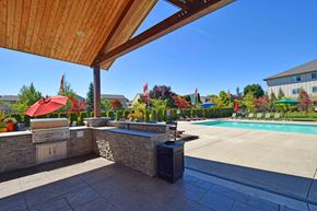 Ridgefield apartment for rent - A pool area with a bar and umbrellas.