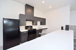 Chico apartment for rent - a kitchen with a white counter top and black appliances