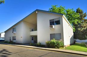 Ontario apartment for rent - A two-story house with a white exterior and a balcony on the second floor.