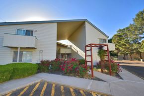 Ontario apartment for rent - A sunny day at a residential building with a red staircase.