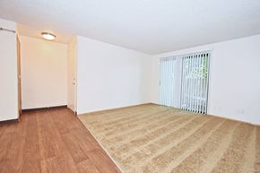 Tualatin apartment for rent - a bedroom with hardwood floors and white walls