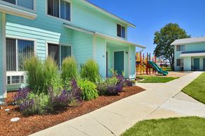 Meridian apartment for rent - a blue house with a playground in front of it