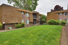 Beaverton apartment for rent - a view of two apartment buildings with a green lawn
