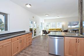 Portland apartment for rent - A kitchen with wooden cabinets and a stainless steel dishwasher.