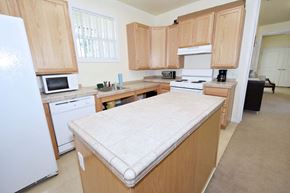 Truckee apartment for rent - a kitchen with wooden cabinets and a white counter top