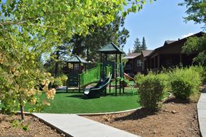 Truckee apartment for rent - a playground with a swing set in front of a house