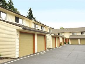Gladstone apartment for rent - a row of garage doors on the side of a building