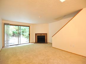 Gladstone apartment for rent - an empty living room with a fireplace and a sliding glass door